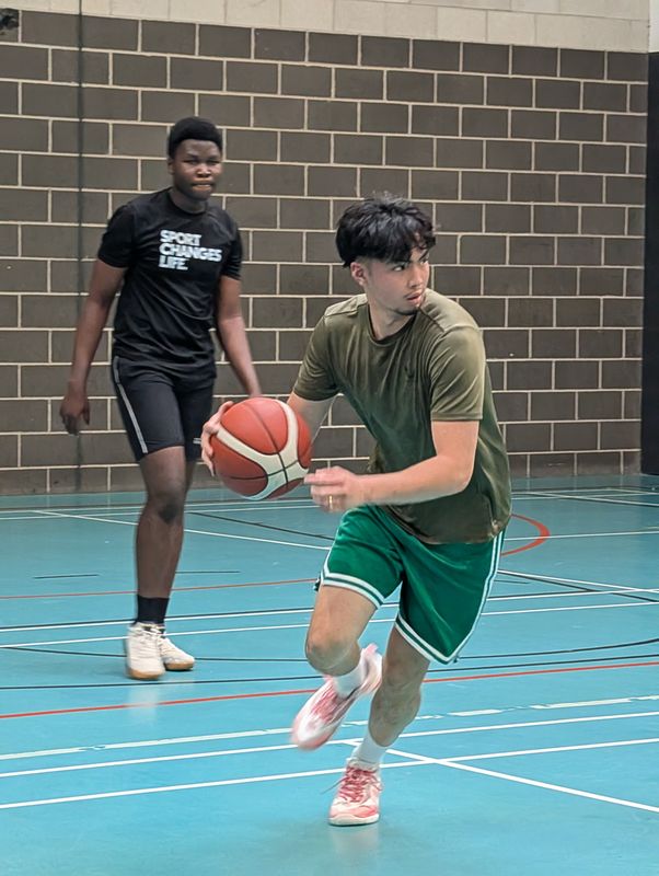 A player in green attacking the gap with the ball