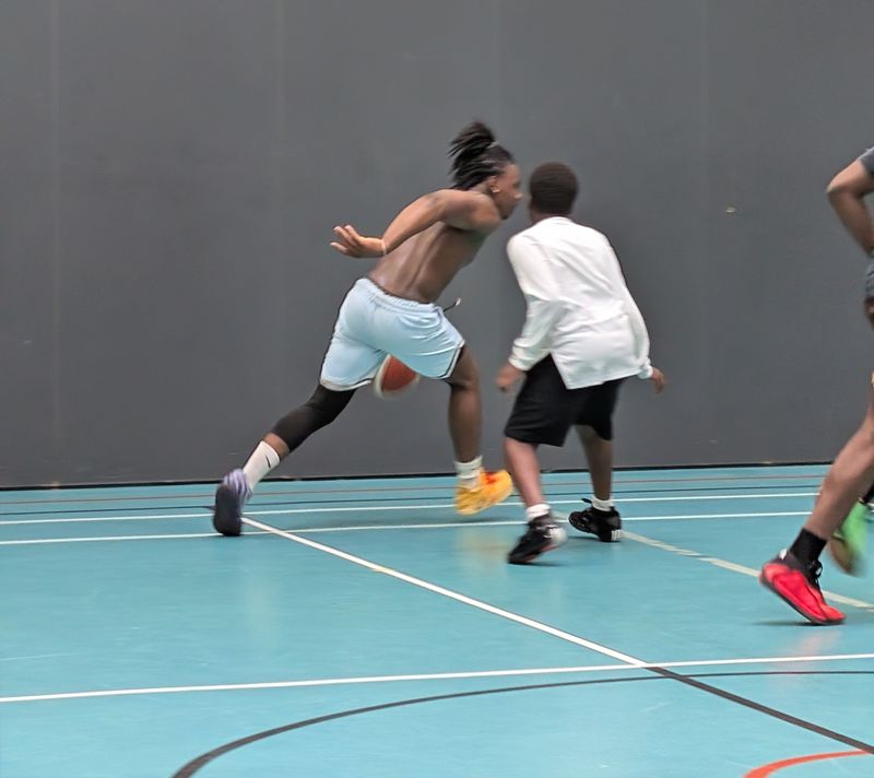 A player driving past a defender with the ball