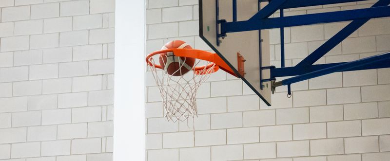 A basketball dropping through the hoop