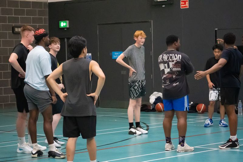 Players and staff talking between drills on the court