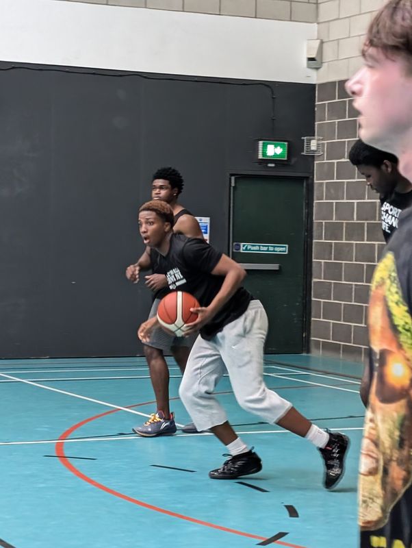 A player protecting the ball from a defender