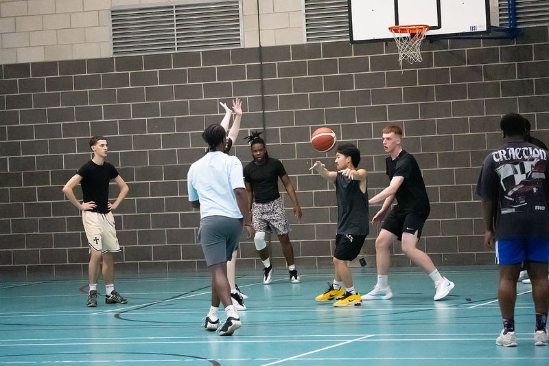 Players battling for position under the basket during a scrimmage