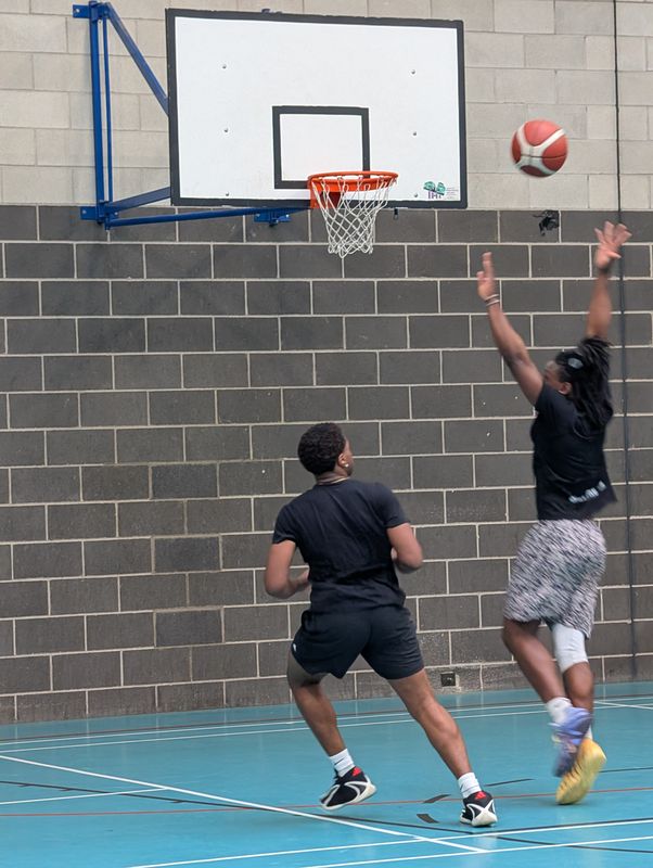 A player releasing a shot over a defender